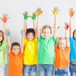 Group of multiracial funny children. Funny kids hands up. World Conference for Well-being of Children in Geneva, Switzerland, at June 1. Universal Children's Day on 20 November.