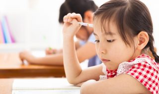 little girl thinking in the classroom
